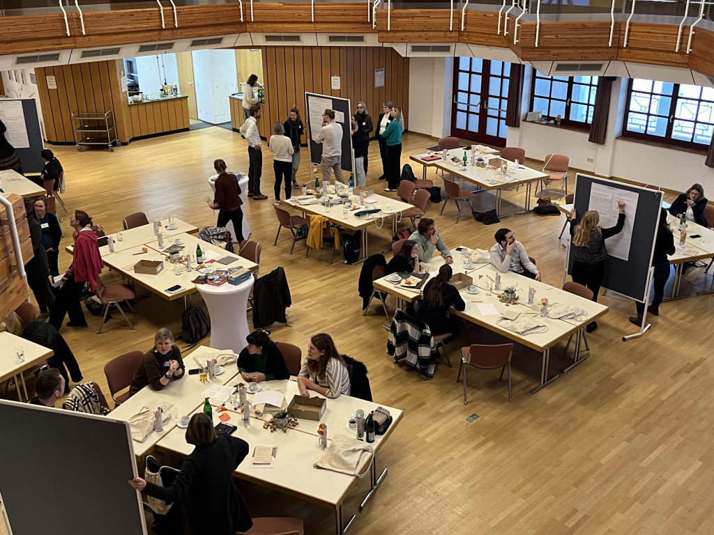 Room with tables and participants worked diligently and exchanged ideas.